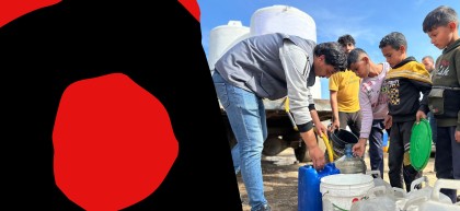 Children and a man gather around water containers in Gaza as clean water is distributed from a yellow hose into jerrycans and buckets, with large white water tanks on a truck in the background.