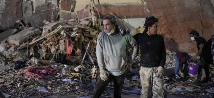 People stand at the site of a collapsed building following an earthquake in Caracas on June 25, 2026