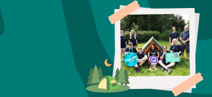 A teal graphic with abstract curved shapes creates a camping-themed backdrop. On the right, a polaroid-style photo, taped at the corners, shows a group of Scouts and volunteers gathered around a tent, with Concern Worldwide and Q Radio signs visible. At the bottom of the photo are illustrated pine trees, a camping tent and a crescent moon.