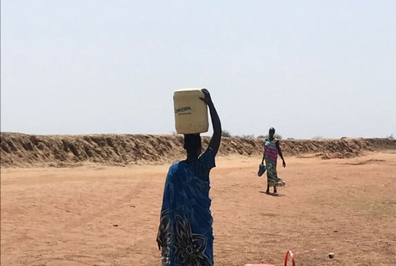A woman in South Sudan collects water. Concern is providing clean water to thousands of people in Unity through a combination of surface water and boreholes. Photo: Susan Finucane/Concern Worldwide