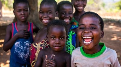 Children in Malawi gather and smile for the camera. Photo: Jennifer Nolan/Concern Worldwide.