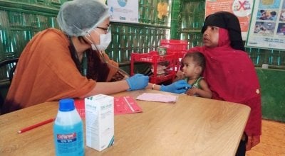 A Nurse of a Concern Supported Nutrition Site in Rohingya Refugee Site is performing clinical assessment of a Severely Malnourished child. Photo: Md. Al-Nasim / Concern Worldwide