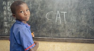 A student in class 1 at Benevolent Islamic Primary School in Makinth community writes on the black board