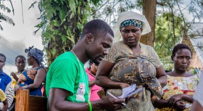 A Concern staff member checks the names of IDPs who have been registered to receive assistance in the Democratic Republic of Congo. Photo: Esdras Tsongo/Concern Worldwide