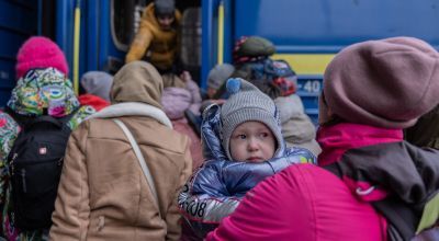 Daria* 2 years old, with her mother, boarding a train having fled their home. Photo: Stefanie Glinski/Concern Worldwide