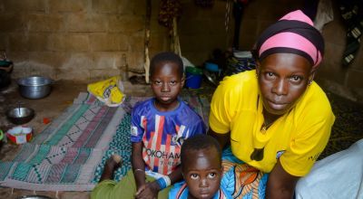 Sylvie, an internally displaced person, with two of her children in Burkina Faso.