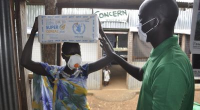 William Bol distributes supplementary food in South Sudan. Photo: Samir Bol