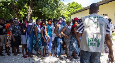 Residents line up as a staff of Concern Worldwide talks to them during a distribution of hygiene kits in district of Port-au-Prince, Haiti. Photo: Dieu Nalio Chery/Concern Worldwide