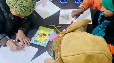 Children do art at a non-formal education (NFE) school in Northern Syria