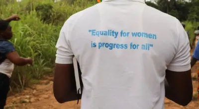 A man in Sierra Leone wears a gender quality t-shirt