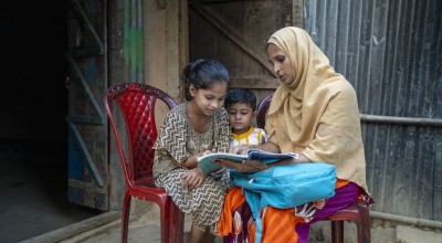 Renu Ara Begum (35) mother of three children and beneficiary of Concern Worldwide’s small business (tailoring). Renu Ara reading with her daughter Jhumka (10) at home in Ratna Palong, Ukhiya, Cox's bazar. Photo: Saikat Mojumder/Concern Worldwide
