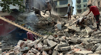 People stand on top of rubbble from the Myanmar earthquake