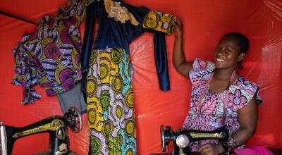 Mother-of-five Alice(27) fled to Mangothe with three children in 2022. Her youngest child is one month old. Alice runs a successful dressmaking and fabric selling business. She owns five sewing machines and is training other women to tailor and helping them to set up their own businesses. Photo: Eugene Ikua/Concern Worldwide