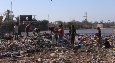 Children in Gaza search through a rubbish dump.
