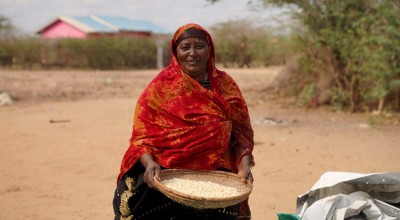 Ralia at her home with her harvested maize which she is currently putting in storage, Tana River, Kenya. Photo: Eugene Ikua/Concern Worldwide.