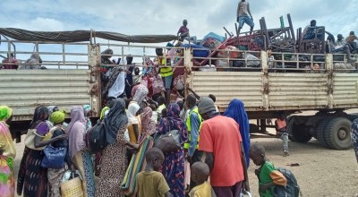 Families board the IOM truck for OTA Photo: CEN.