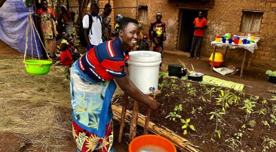 Maman Lumiere (lead mother) demonstrating hand washing in Karusi, Burundi. Photo:  Diane Moyer/Concern Worldwide.