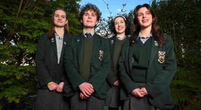 Four secondary school students standing together