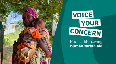 A woman wearing a patterned headscarf stands outdoors holding a young child in her arms beneath leafy trees. On the right side of the image, bold campaign text reads “VOICE YOUR CONCERN” alongside the message “Protect life-saving humanitarian aid” on a teal graphic background. The image conveys the human impact of humanitarian aid and advocacy for protecting international assistance.