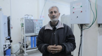 A man stands in front of a water filter in a hospital