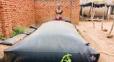 Ligness Mpoto of Mtali Village in the Kakuyu Watershed with her biodigester. Photo: Concern Worldwide.