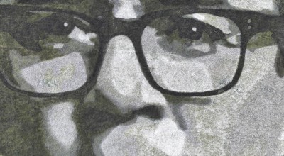 A close up of Andy Burnham's face drawn in greyscale on a field