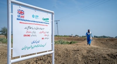 A UK Aid logo and a Concern Worldwide logo on a sign in Pakistan