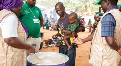 Imenje*, brings his son, Guy*, to receive the nutritious porridge in CAR. Photo: Mussa Uwitonze/Arete/Concern Worldwide.