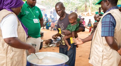 Imenje*, brings his son, Guy*, to receive the nutritious porridge in CAR. Photo: Mussa Uwitonze/Arete/Concern Worldwide.