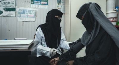 Woman providing health check up to a patient