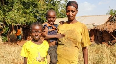 Nasino Asuran (20) is six months pregnant with her third child. Pictured here with her daughter Nangiro and son Sampson, the family are malnourished and have not eaten all day, they normally eats boiled maize once a day. Leyai Village, Marsabit, Kenya.