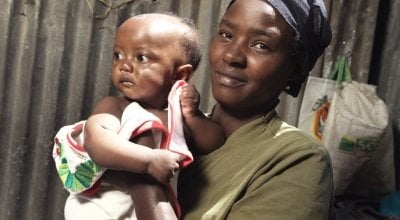 Florence Mutungi (32) with six-month-old Precious - one of her twin daughters. Florence and her husband are bringing up their five children in their one room house in one of Nairobi’s largest slums, Mukuru where chronic malnutrition and stunting is a majo