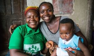 Maternal and Newborn Health Promoter Kai Jigba with a Concern-trained former traditional birth attendant Maddie Sanoh and baby Mamie. Photo: Kieran McConville / Concern Worldwide.