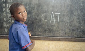 A student in class 1 at Benevolent Islamic Primary School in Makinth community writes on the black board