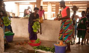 Rose and Stone selling freshly picked produce from the family farm in Nsanje, Malawi. Stone and Rose are participants in the Graduation Programme / Umodzi project. Photo: Chris Gagnon/Concern Worldwide.