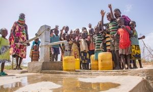 Regina Ekiru (30) and some children from Kadak Aikeny village, Turkana, Kenya at a well that Concern rehabilitated. May 2022. Photo: Gavin Douglas/Concern Worldwide.