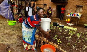 Maman Lumiere (lead mother) demonstrating hand washing in Karusi, Burundi. Photo:  Diane Moyer/Concern Worldwide.
