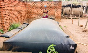Ligness Mpoto of Mtali Village in the Kakuyu Watershed with her biodigester. Photo: Concern Worldwide.