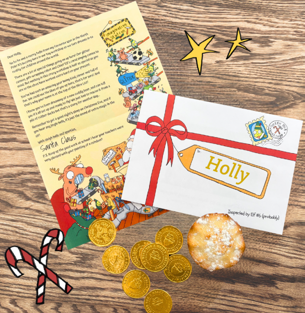 A personalised Santa Letter from Concern, with an illustrated envelope labelled “Holly,” festive chocolate coins, a candy cane illustration, and a mince pie on a wooden background.