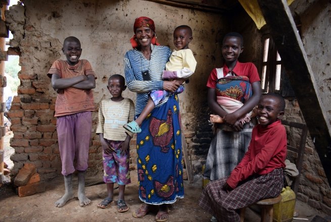 Violette Bukeyeneza was selected to be part of Concern’s Graduation programme. She can be seen here with her children. Renovations on her house have now begun, and she has also started a small business selling banana juice twice a week – and has earned enough to buy a goat. She now has plans to convert her front room into a small grocery shop. Burundi. Photo: Darren Vaughan/Concern