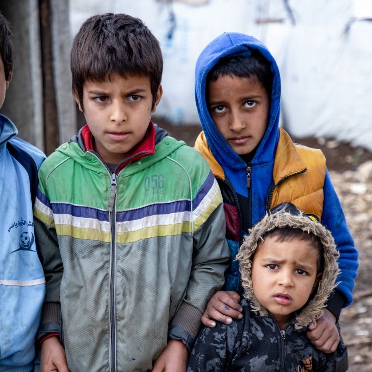 Three children in refugee camp
