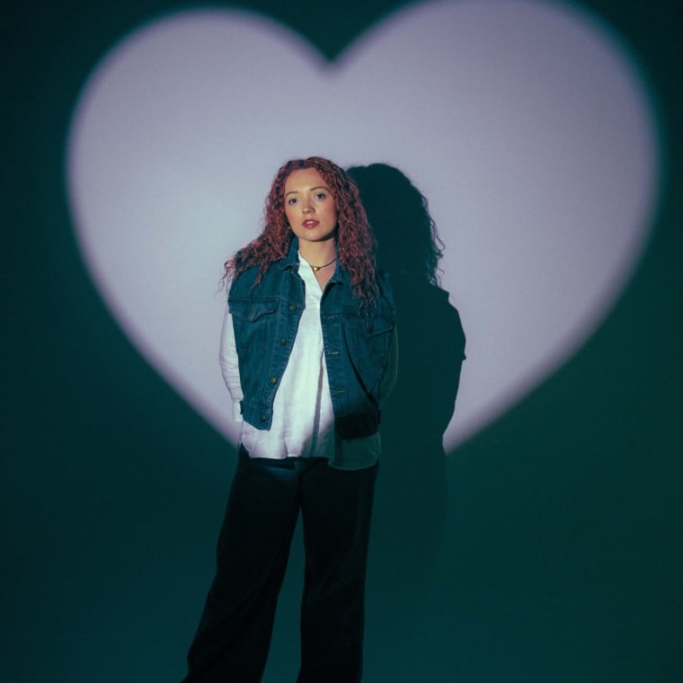 Bea Stewart standing in a heart spotlight